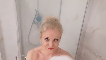 Middle-Aged Blonde With Large Breasts Enjoys A Hot Shower